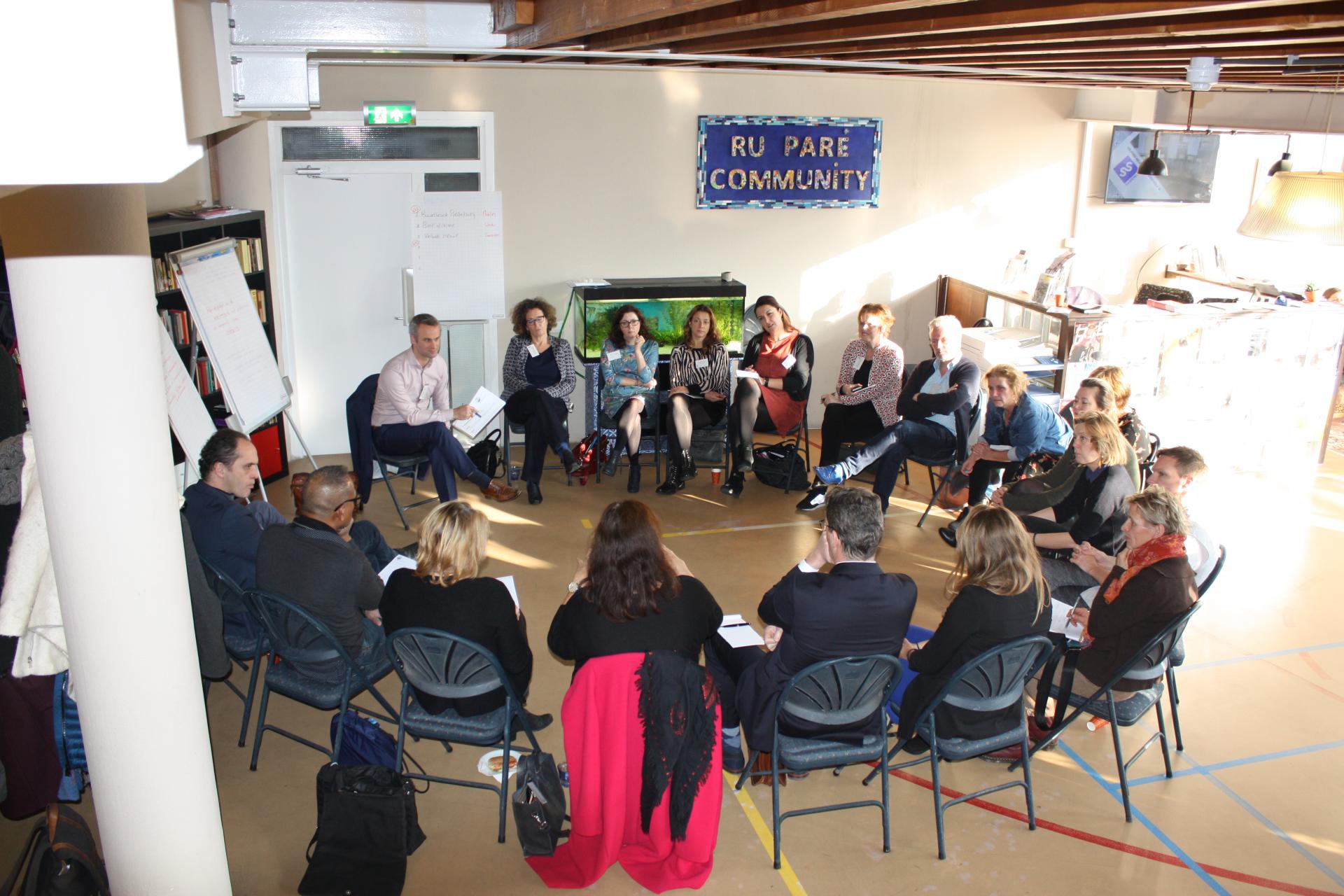 Groep mensen op stoelen in een kring